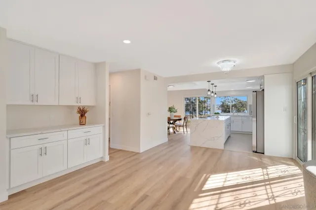 a view of a kitchen with wooden floor and electronic appliances