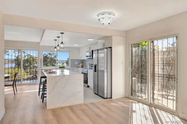 a living room filled with furniture and a large window