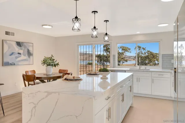 a large white kitchen with a large window
