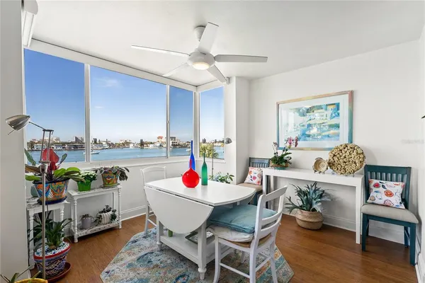 a utility room with white cabinets and clock on the wall