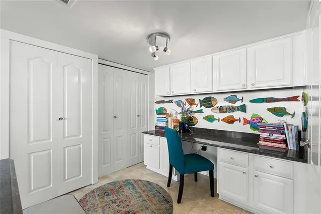 a large bedroom with a large bed and large windows