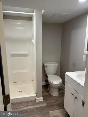 a white toilet sitting next to a bathroom sink