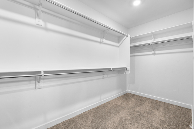 788 West 2840 South, Unit 2 Logan, UT 84321 - Photo 21 of 21 Walk-in closet featuring built-in shelving, hanging rods, recessed lighting, and carpet flooring