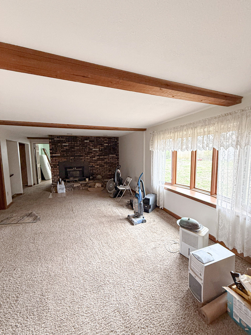 1599 East 2700 North Road Clifton, IL 60927 - Photo 13 of 26 a living room with furniture a window and gym equipment