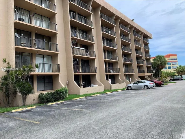 a view of street with large windows and a yard