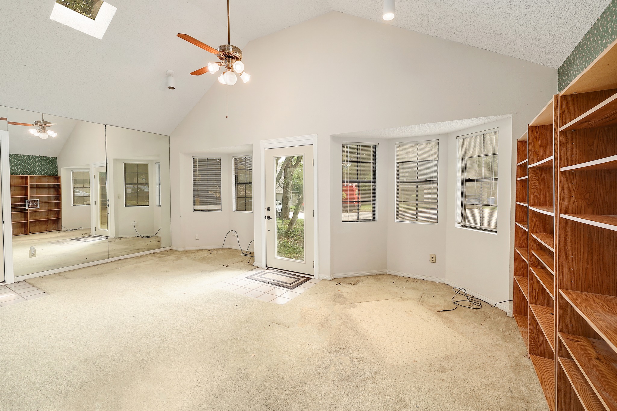 2202 Warfield Way Austin, TX 78728 - Photo 21 of 32 A versatile open-plan room with vaulted ceilings and abundant natural light features built-in shelving.