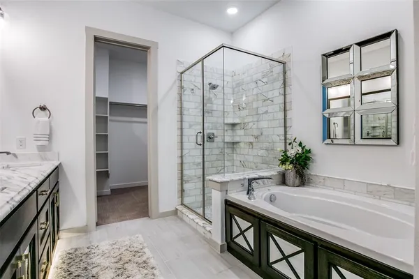 a bathroom with a granite countertop sink a mirror and a shower