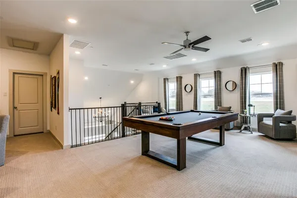 a room with furniture pool table and windows