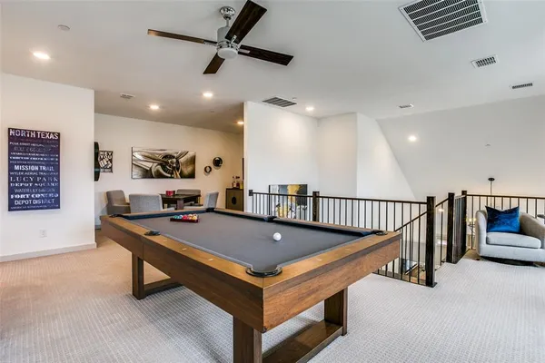 a living room with pool table and a table