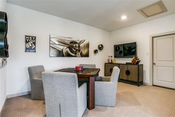 a view of a workspace with furniture and a flat screen tv