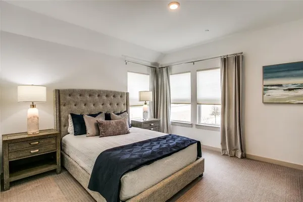 a bedroom with a large bed and a tv