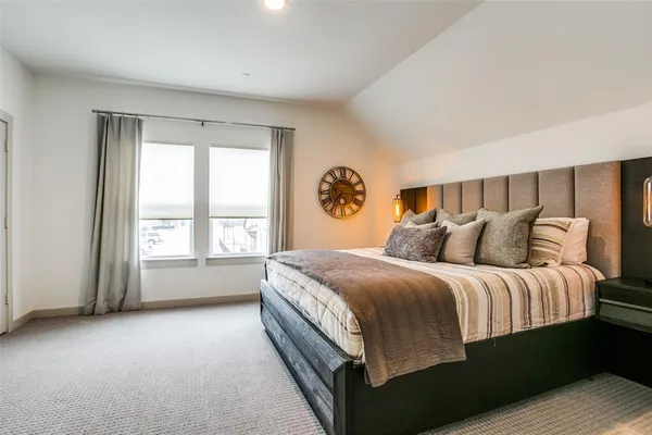 a bed sitting in a bedroom next to a window