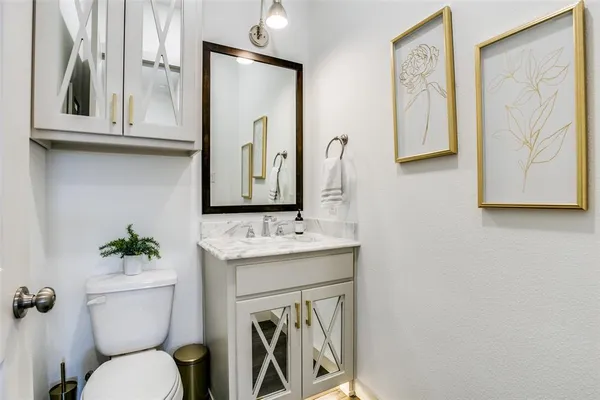 a bathroom with a toilet a sink and mirror