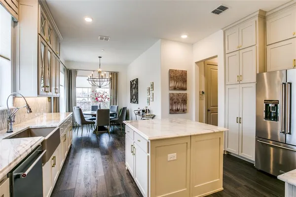 a kitchen with sink refrigerator and cabinets