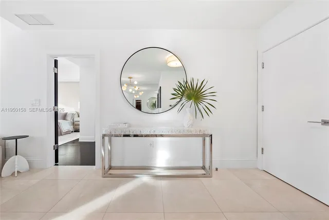 a bedroom with a bed and large window with balcony view