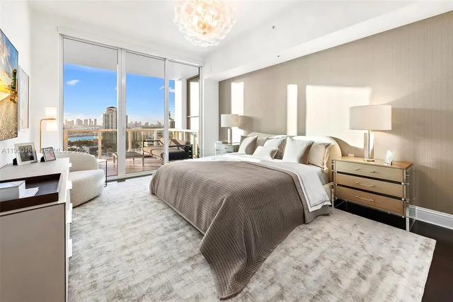 a bedroom with a bed a couch and large window