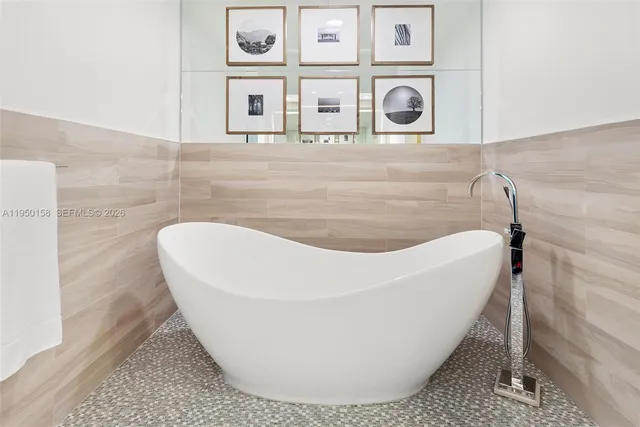 a kitchen with a sink a counter top space and a view of living room
