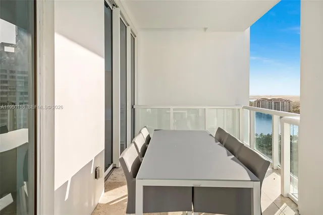 a large bedroom with a large bed and a flat tv screen on dresser