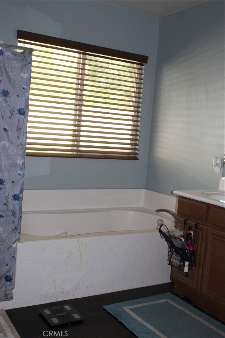 1382 Sunset Avenue Perris, CA 92571 - Photo 16 of 23 a bathroom with a bathtub and a window