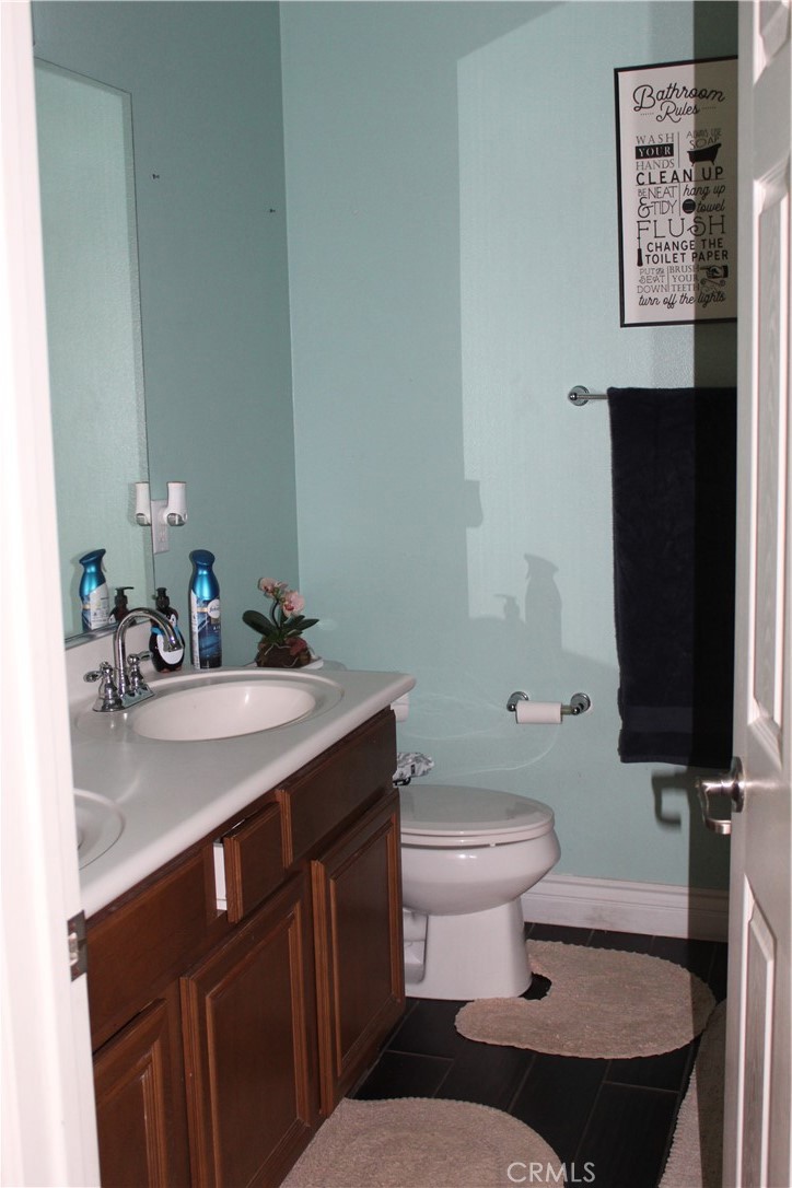 1382 Sunset Avenue Perris, CA 92571 - Photo 19 of 23 a bathroom with a sink and a toilet