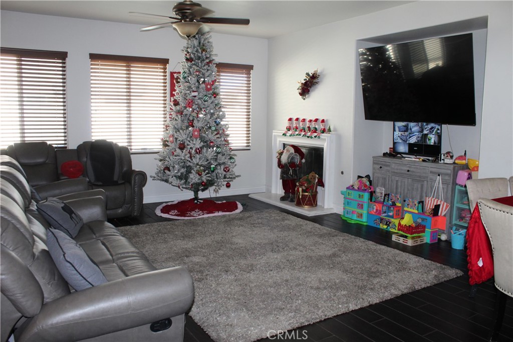 1382 Sunset Avenue Perris, CA 92571 - Photo 8 of 23 a living room with furniture and a flat screen tv