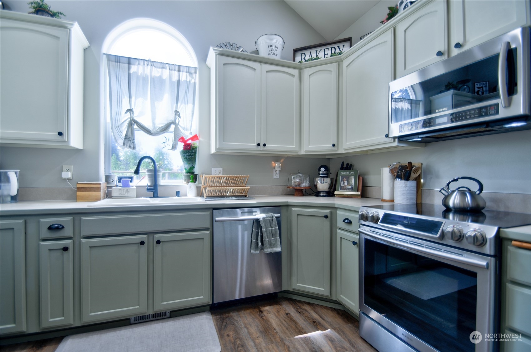 16637 Sheldon Lane Southwest Rochester, WA 98579 - Photo 13 of 40 a kitchen with stainless steel appliances granite countertop a sink dishwasher a microwave oven and cabinets with wooden floor