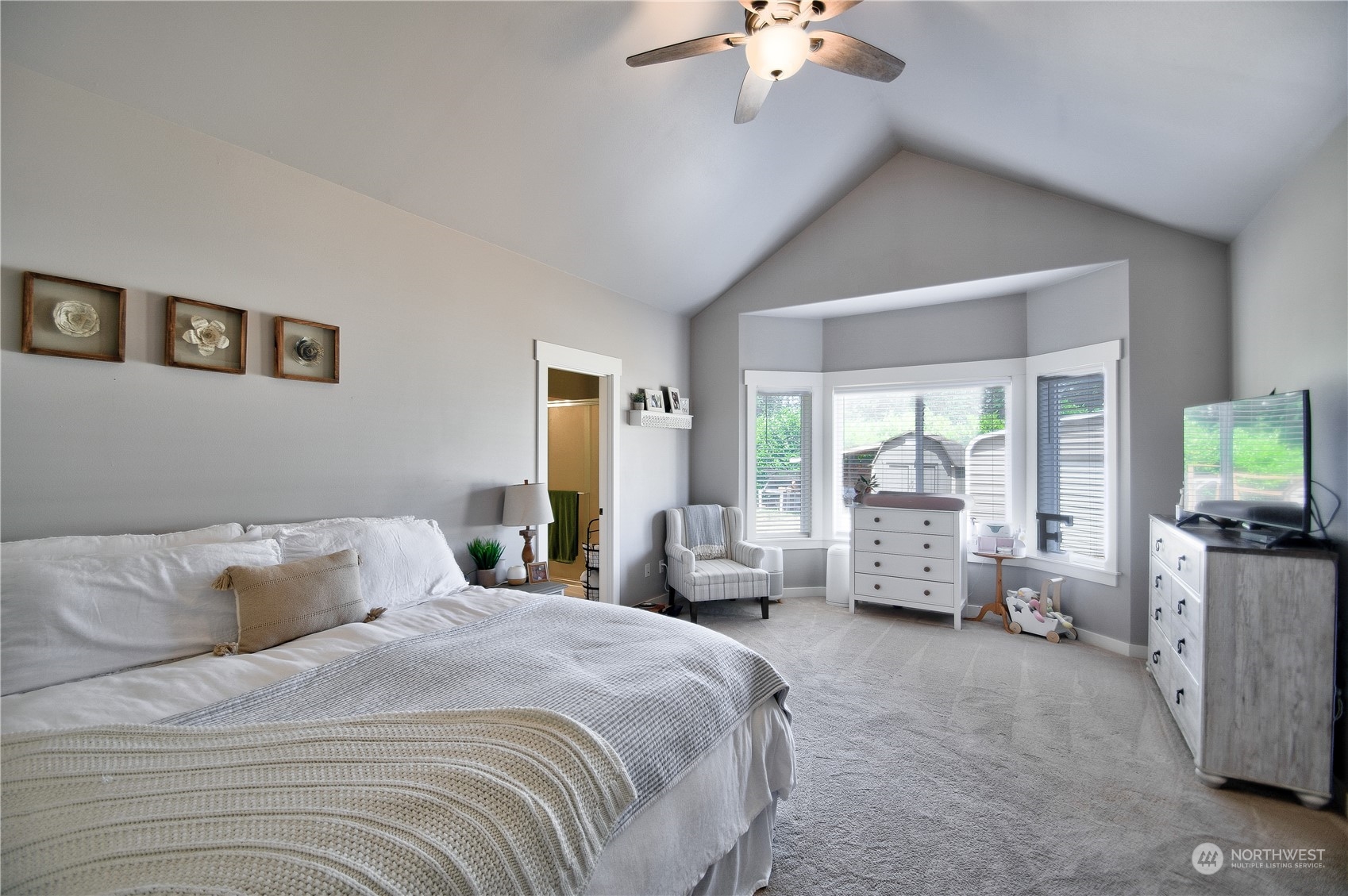 16637 Sheldon Lane Southwest Rochester, WA 98579 - Photo 17 of 40 a bedroom with a large bed and a chandelier fan