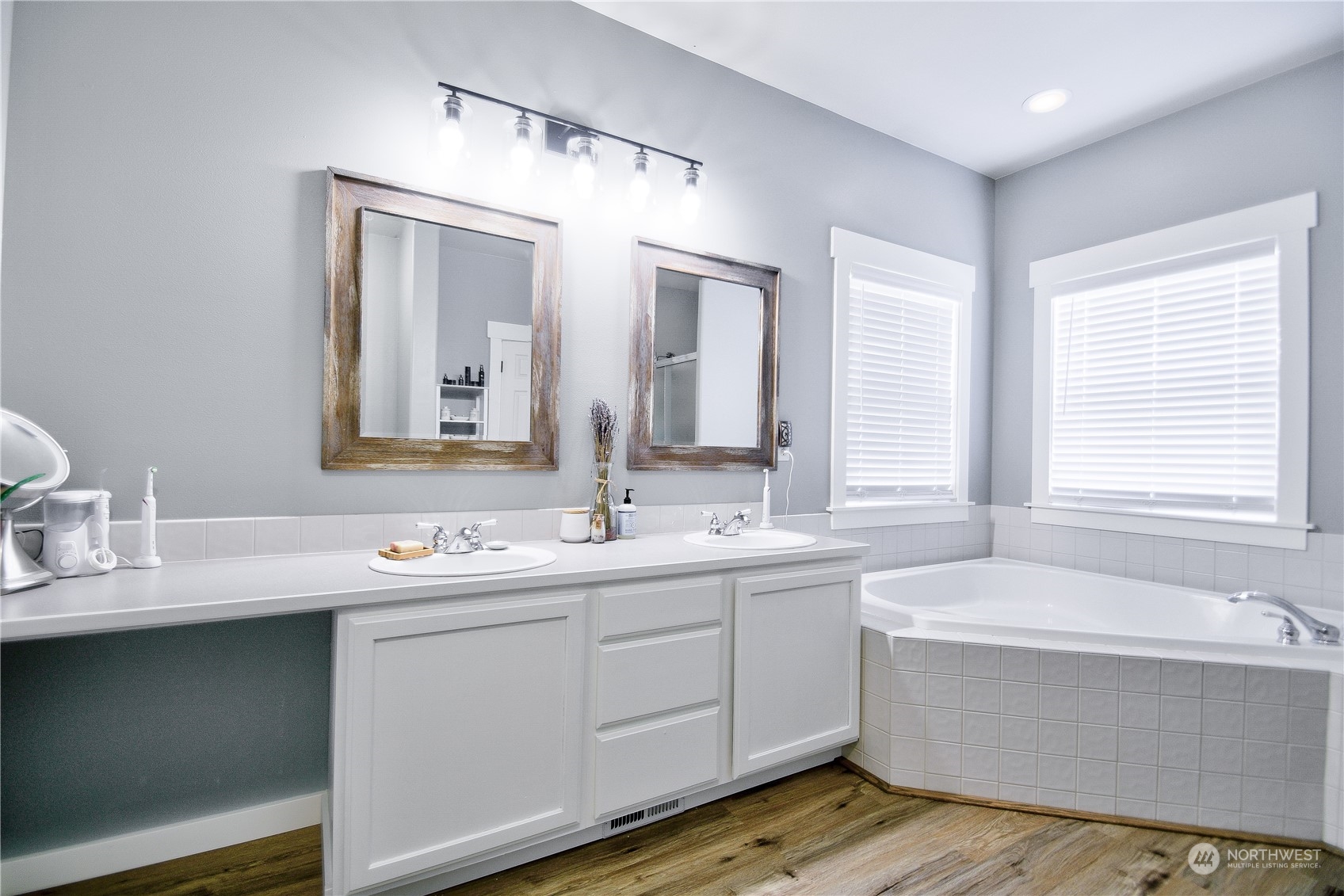 16637 Sheldon Lane Southwest Rochester, WA 98579 - Photo 20 of 40 a bathroom with a double vanity sink mirror and a bathtub
