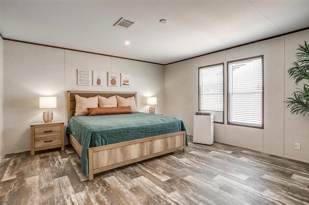 242 Huddleston Road Sunset, TX 76270 - Photo 11 of 18 a bedroom with a large bed and a window