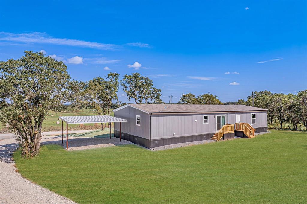 242 Huddleston Road Sunset, TX 76270 - Photo 16 of 18 a view of a terrace with a yard
