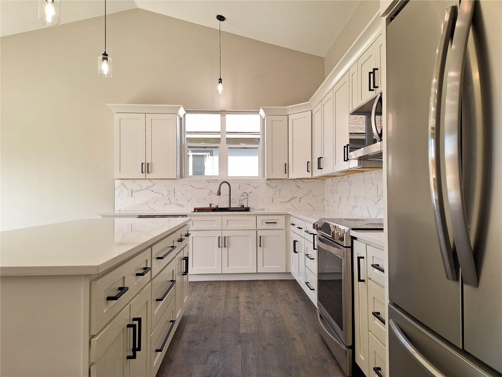 a kitchen with stainless steel appliances white cabinets and a sink