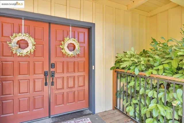 a view of dining room and livingroom with furniture wooden floor a rug and a chandelier