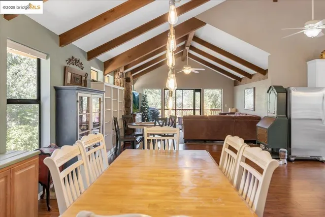 a roof deck with table and chairs and potted plants