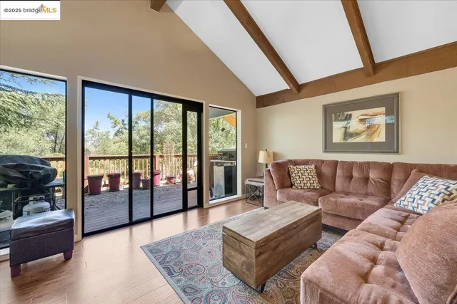a dining room with wooden floor and large window