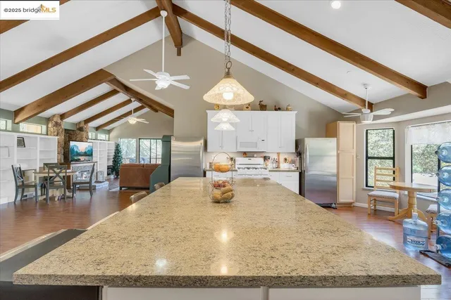 a bathroom with a granite countertop sink mirror and vanity