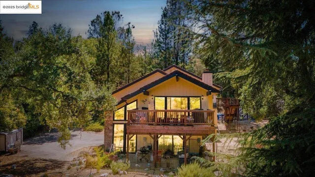 a view of a large trees in front of a house