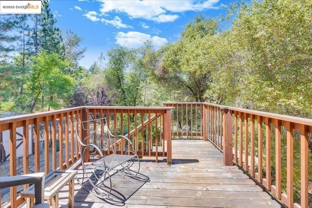 a view of a hallway with a livingroom and a bathroom with a sink