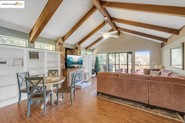 a living room with furniture a flat screen tv and a large window