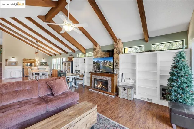 a living room with furniture and a floor to ceiling window