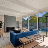 a living room with furniture and large windows