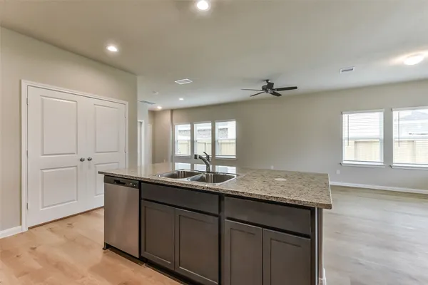 a bathroom with a granite countertop sink mirror and cabinets