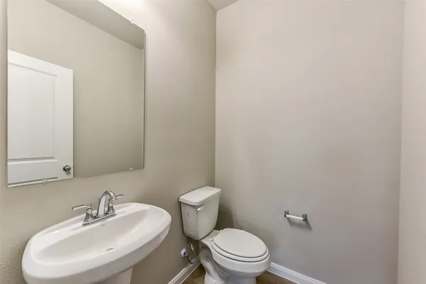 a white toilet sitting next to a bathroom sink