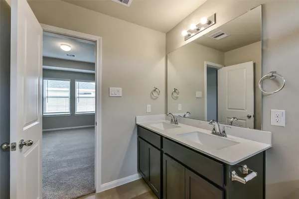 a bathroom with a sink double vanity and a mirror