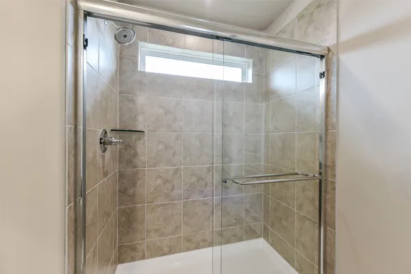 a bathroom with a glass shower door