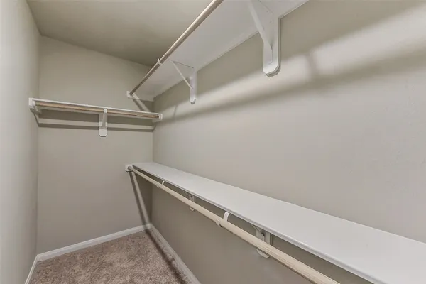 a view of utility room with racks on the wall