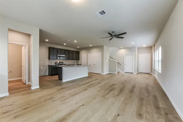 a view of kitchen with stove and refrigerator