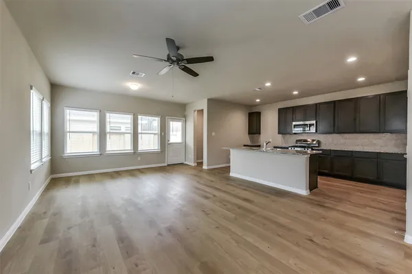 a view of kitchen with sink and wooden floor