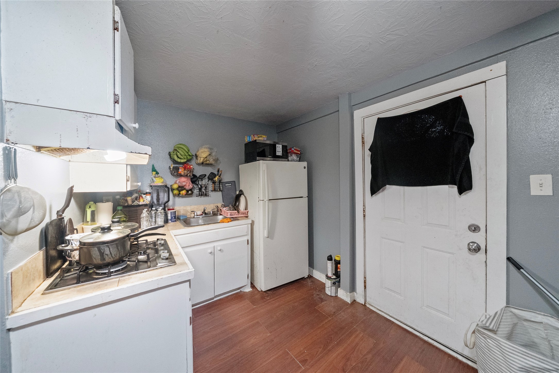7938 Kerr Street, Unit 6 Houston, TX 77029 - Photo 15 of 18 a kitchen with a refrigerator and a stove top oven