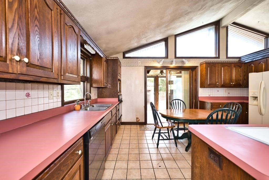 38 Gaudette Street Fall River, MA 02721 - Photo 27 of 41 a kitchen with stainless steel appliances granite countertop a stove a sink and a microwave