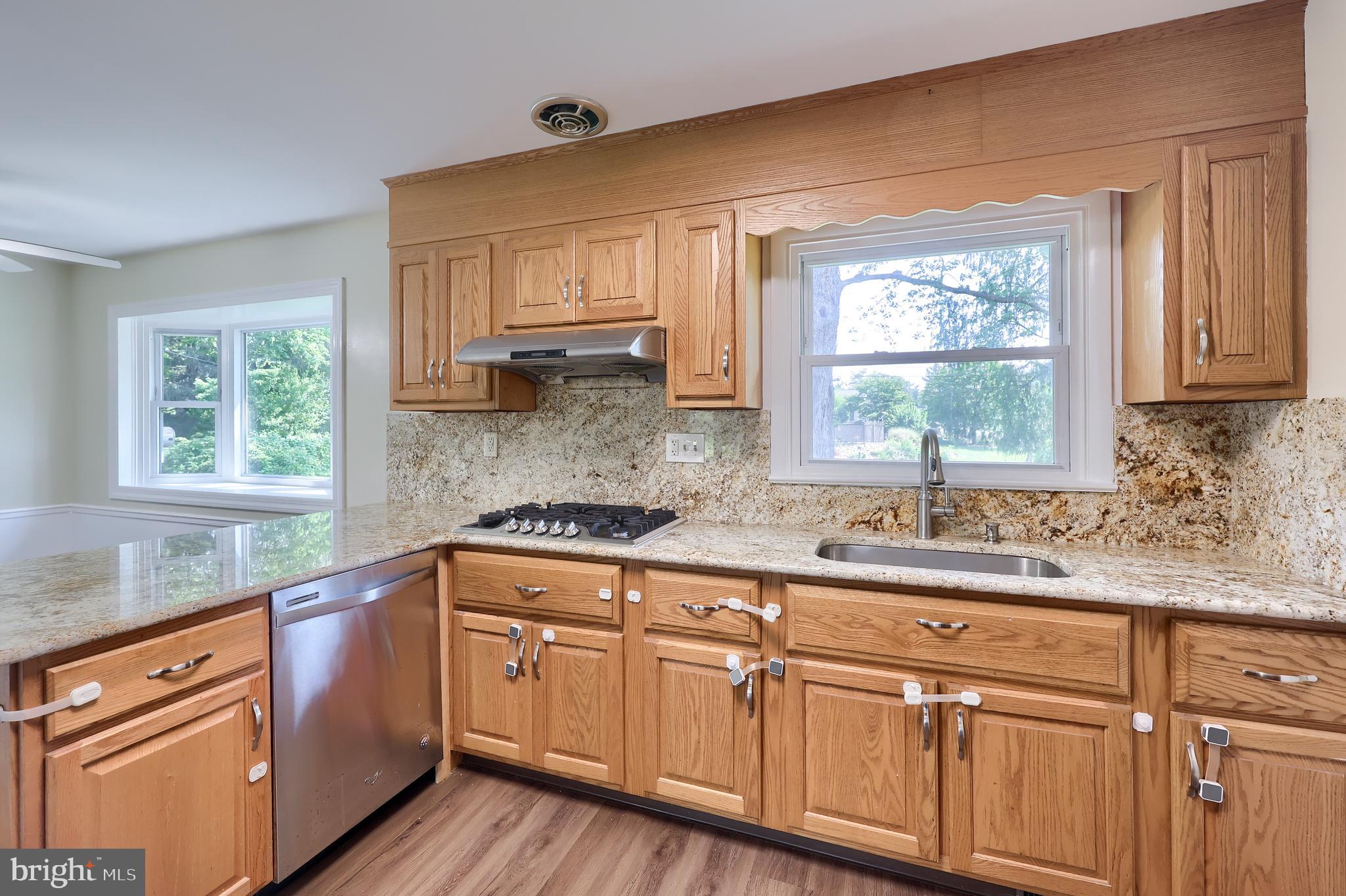 1046 Hunsicker Road Lancaster, PA 17601 - Photo 11 of 31 a kitchen with stainless steel appliances granite countertop white cabinets sink and window